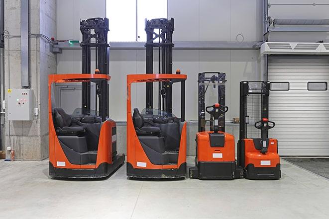 workers operating forklifts at warehouse